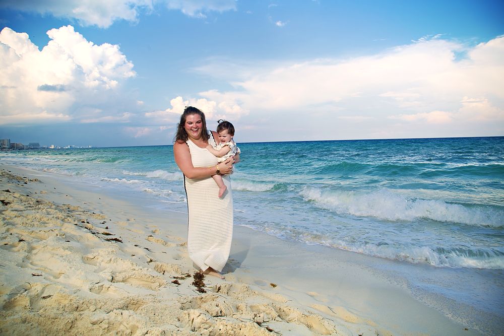 Mom walking the beach with her baby