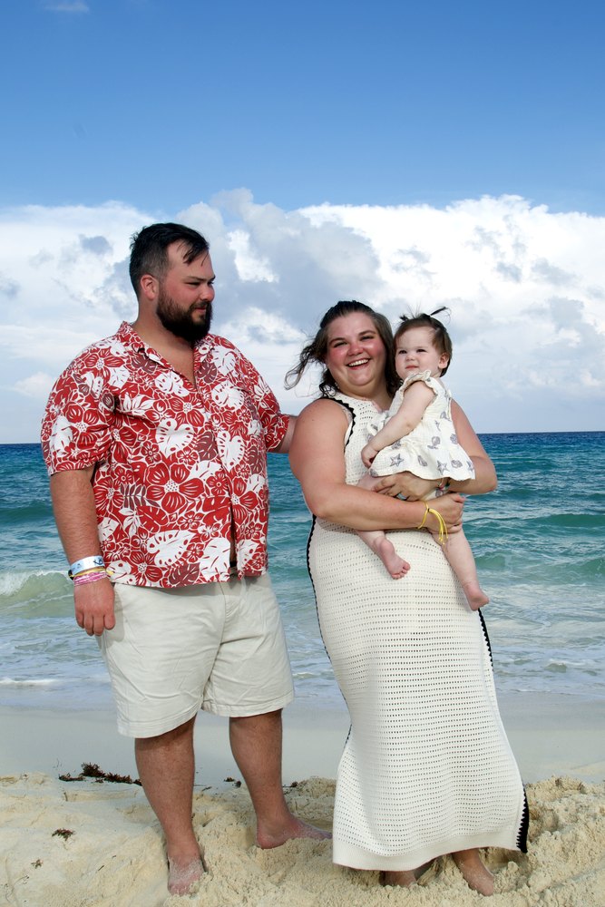 Mom, dad and their baby girl on the shore